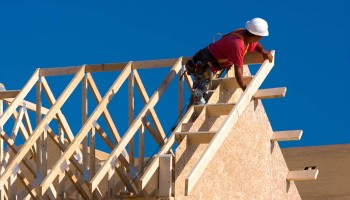 construction worker assembling roof beams